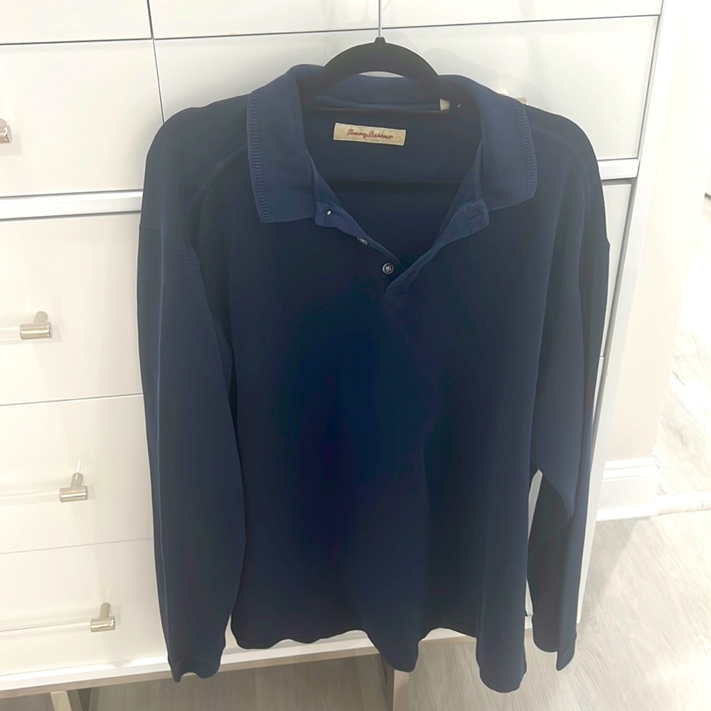 This is a dark blue Tommy Bahama, long sleeve cotton shirt. three button at neck